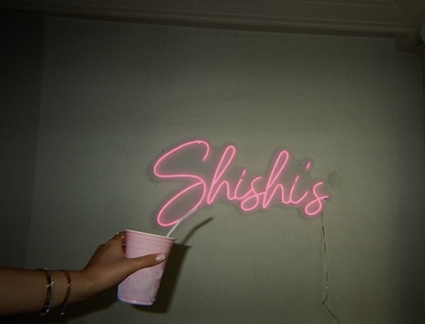 Pink neon and a raised cup